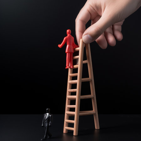 Businessman hand placing red wooden man doll on top of ladder on black backgroundの素材