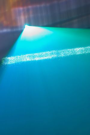 Color laser beams fantail in a haze and water wallの写真素材