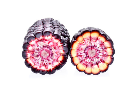 Ripe purple corn on white backgroundの写真素材