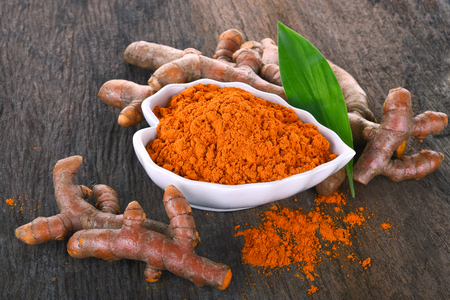 Fresh turmeric roots on wooden tableの写真素材