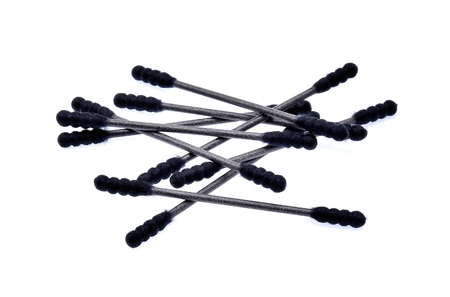 Black cotton sticks (cotton buds) on white backgroundの写真素材