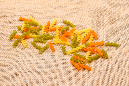 Colored pasta on rustic fabric backgroundの写真素材