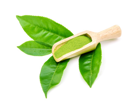 powder green tea and green tea leaf isolated on white backgroundの写真素材