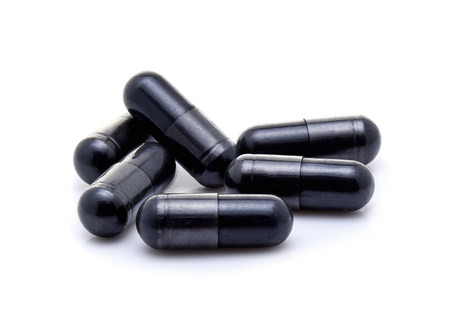Charcoal capsules isolated on white backgroundの写真素材