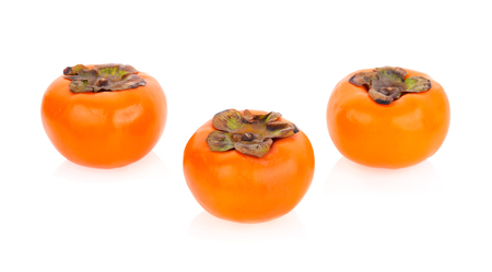 ripe persimmons isolated on white backgroundの写真素材