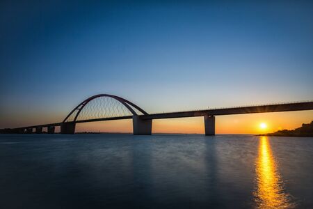 The Fehmarnsund Bridge in front of Fehmarn in the sunsetの写真素材