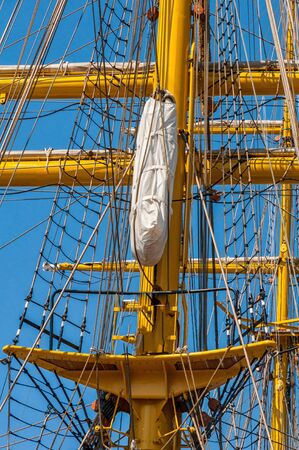 The rigging on the mast of a sailing ship