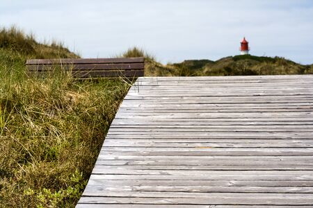 Wooden path to the lighthouse on the North Frisian island of Amrum