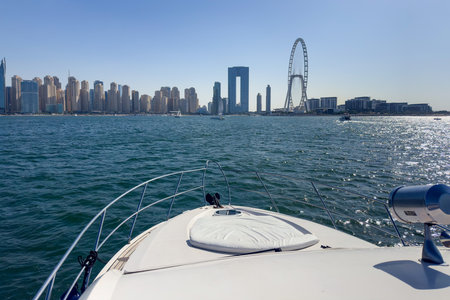 Luxury Dubai Marina skyscrapers, boat and promenade in beautiful summer day, Dubai, United Arab Emiratesの写真素材