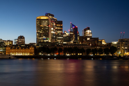 Skyscrapers on the Thames in London at nightの写真素材