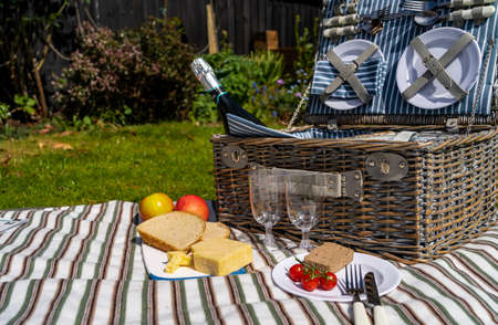 Picnic lunch is ready to be enjoyed with food and sparkling wineの写真素材