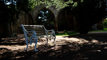 White Benchnext to old church ruinsの写真素材