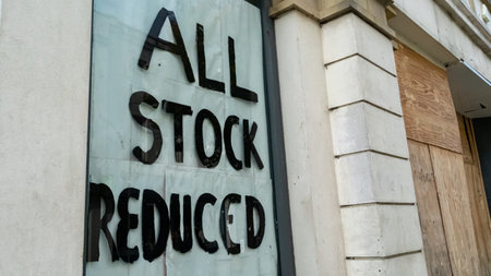 All Stock Reduced sign in a boarded-up shop windowの写真素材