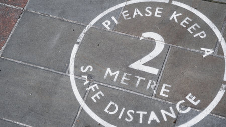 Two Metre social distancing painted sign in a high streetの写真素材