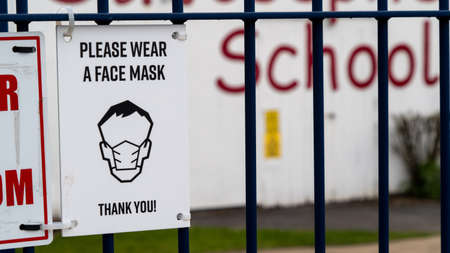 Sign outside a school requesting face masks be worn