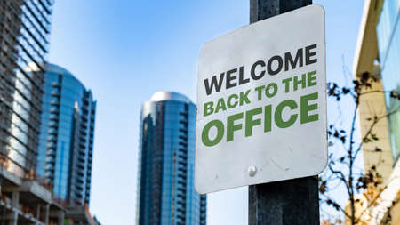 Welcome back to the office Worn Sign in Downtown city settingの写真素材