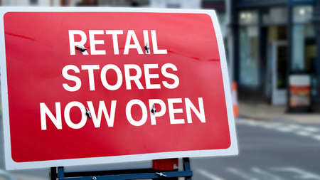 Retail stores now open sign in a city-centreの写真素材