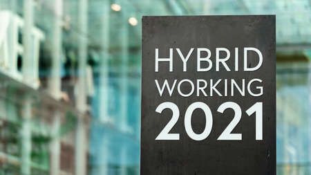 Hybrid Working 2022 sign in front of a modern office buildingの写真素材