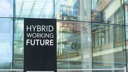 Hybrid Working Future sign in front of a modern office buildingの写真素材