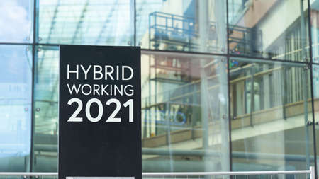 Hybrid Working 2021 sign in front of a modern office buildingの写真素材