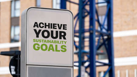 Achieve Your Sustainability Goals sign in a city setting under constructionの写真素材