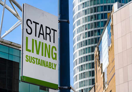 Start Living Sustainably sign in a downtown city centerの写真素材