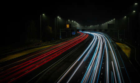 Motorway fast traffic light trails at nightの写真素材