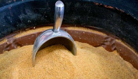 Measuring spoon placed in a mound of spicesの写真素材
