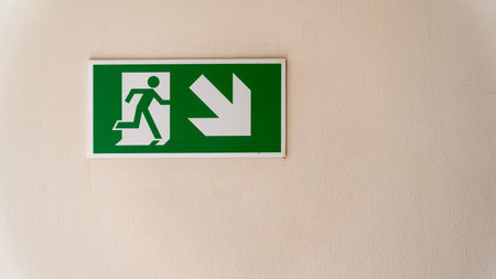 Green Fire Escape Sign on a wall with copy spaceの写真素材