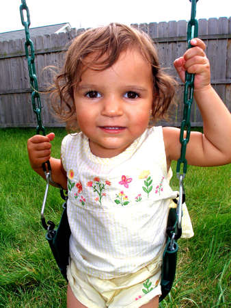 Little girl getting ready to swing.の写真素材