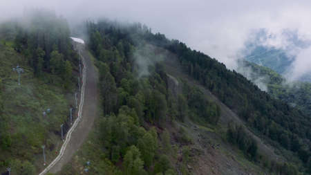 Flying above the clouds in the mountains, cable car in the summerの写真素材