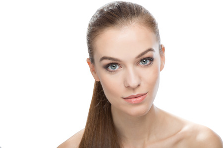Attractive woman over white background with straight hair in a ponytailの写真素材