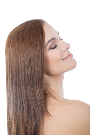 Beautiful smiling girl. Female face close-up. Isolated on a white background. Eyes closed.の写真素材