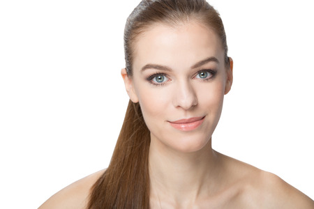 Beautiful young woman with healthy long hairon a ponytail , centered, isoled on white background.の写真素材