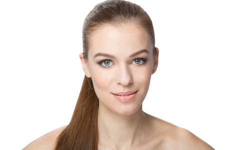 Portrait of Beautiful Young Woman looking at Camera. Isolated on White Background. Fresh Clean Skin.の写真素材