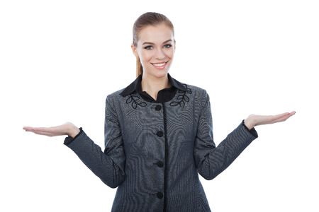 Business with both her empty palms extented sideways presenting copyspace. Quizzical expresion as she indicates that there is a choice or alternative, with copyspace for the placement of your products.の写真素材