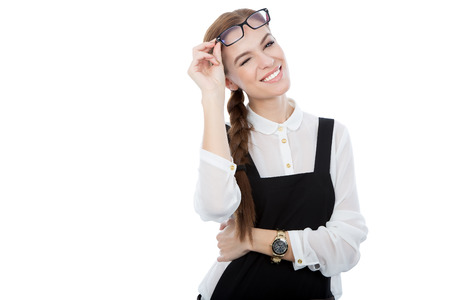 A studio portrait of a beautiful young woman wearing glasses winking at the camera. Isolated on white. Copy space available.の写真素材