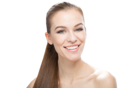 Portrait of smiling beautiful young woman, on white backgroundの写真素材