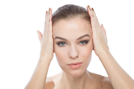 Woman touching or framing her face with her handsの写真素材