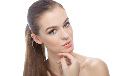 Young woman touching her chin.の写真素材