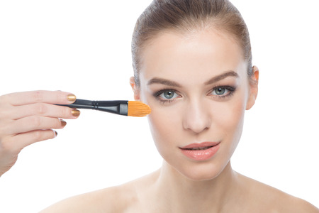 Young woman and a foundition brush.の写真素材