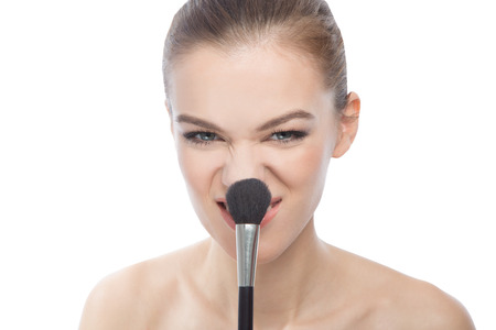 Model plays with a make-up brush.の写真素材