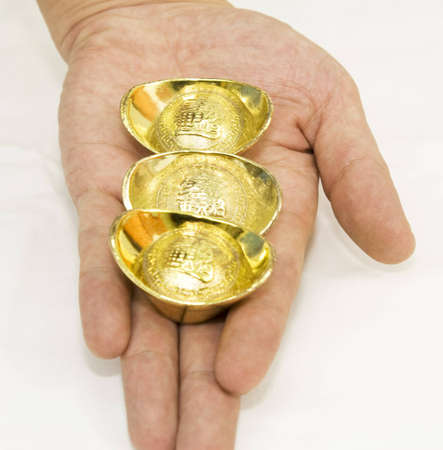 A handful of gold ingotsの写真素材