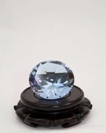 A large blue diamond on a wooden pedestalの写真素材