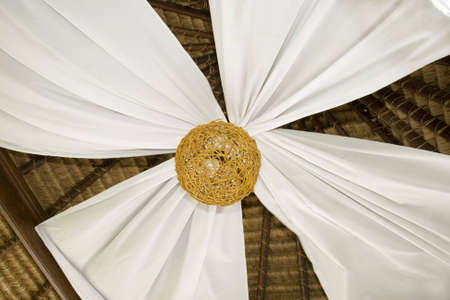 A gazebo ceiling decorated with a floral pattern made of linensの写真素材