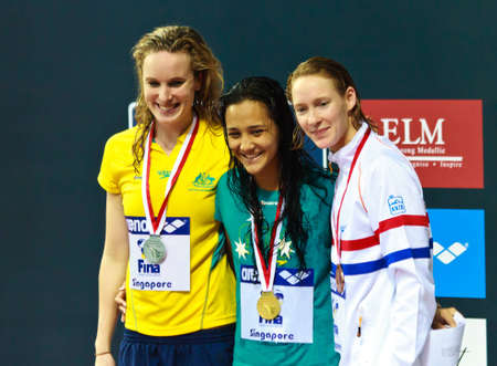 Singapore - Oct. 17: Gold medalist Kotuku Ngwati (AUS), Silver medalist Marieke Guehrer (AUS), bronze medalist H. Schreuder (NED) for the 100m freestyle event at the 2010 Fina Swimming World Cupのeditorial素材