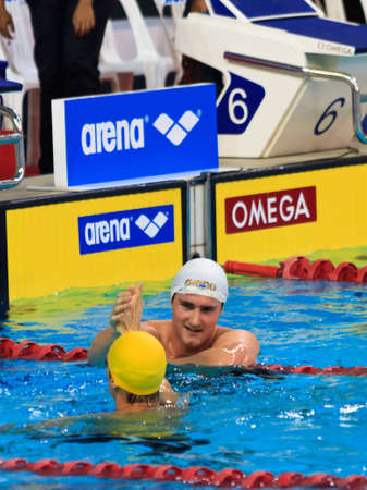 Cameron Van De Burgh is congratulated by fellow RSA countryman, Roland Shoeman,  after winning the 50m backstroke event.のeditorial素材
