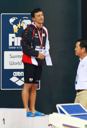 Koehie Kawamoto expresses gratification at earning his bronze medal in the 50m butterfly event at the 2010 Fina Swimming World Cup. Singapore 16/10/2010.のeditorial素材