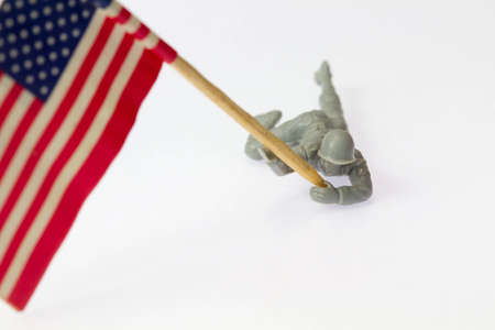 A close up of toy soldier holding up the american flagの写真素材