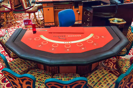 A red felted bacarrat table waiting for players and dealer のeditorial素材